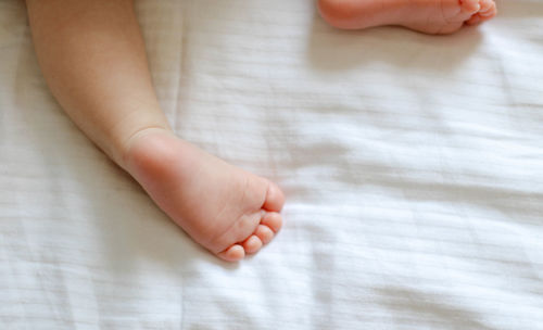 Low section of child on bed