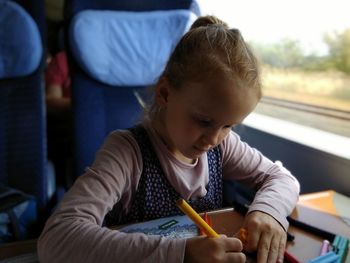 Close-up of writing in book while sitting in train