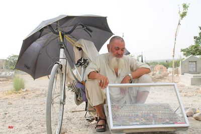 Portrait of smiling man holding umbrella