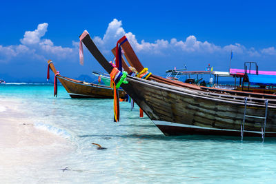 Fishing boat in sea against sky