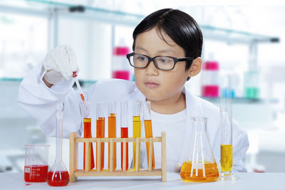 Boy doing experiment in laboratory