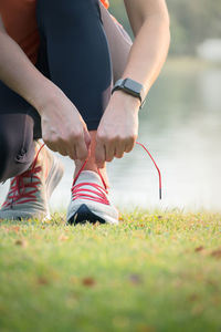 Low section of woman relaxing on field