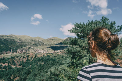 Girl walking along a small path in the mountain of spain. on a sunny summer day