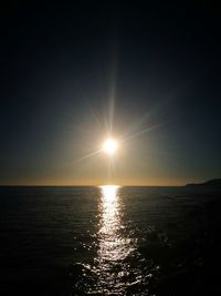 Scenic view of sea against clear sky at sunset