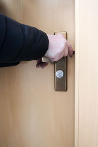 Close-up of human hand on door