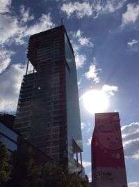 Low angle view of tower against cloudy sky