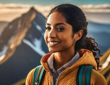 A lone hiker standing triumphantly on the summit of a mountain