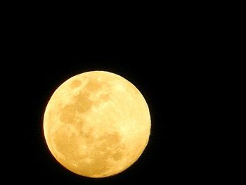 Low angle view of moon against clear sky at night