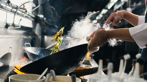 Midsection of man preparing food