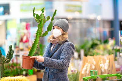 Woman wearing hat standing in store