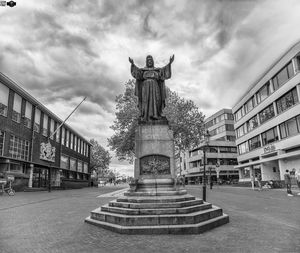 Statue amidst street in city