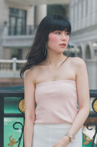 Portrait of a beautiful young woman standing outdoors