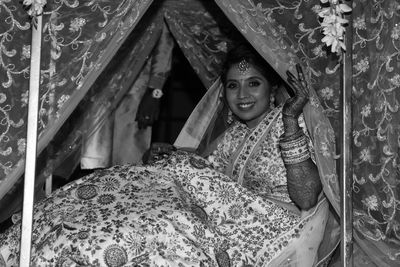 Portrait of young woman lying on bed