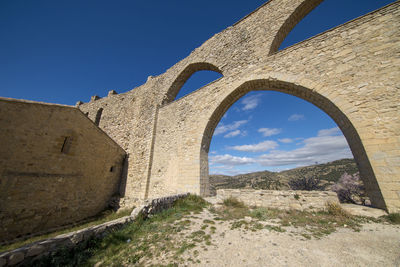 Low angle view of old ruins against sky