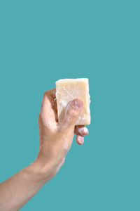 Woman hold soap with foam