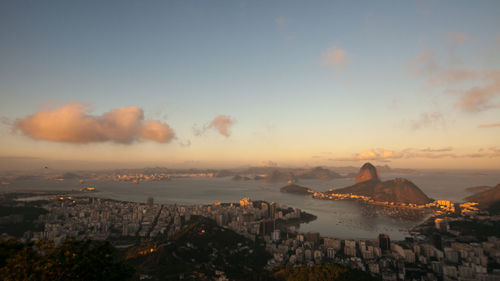 High angle view of city by sea against sky