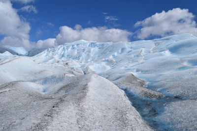 Scenic view of snowcapped landscape against sky