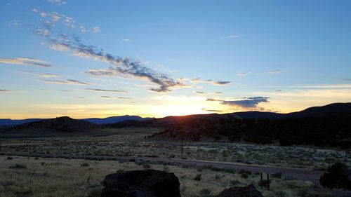 Scenic view of mountains against sky at sunset