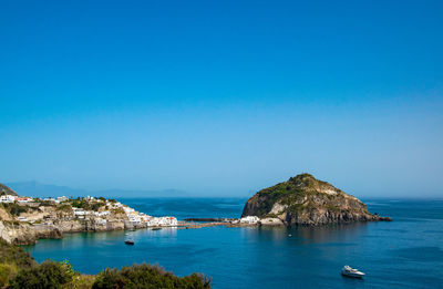 Scenic view of sea against clear blue sky