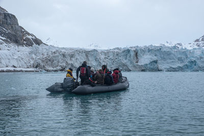 People in boat against sky