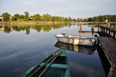 Boats moored in calm lake