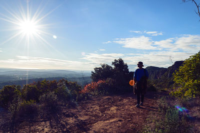 Full length of man walking on landscape against sky