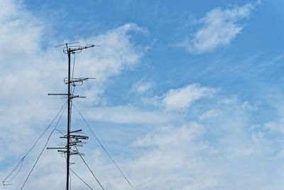 Low angle view of television antenna against sky