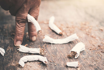 Cropped image of hand holding cigarette