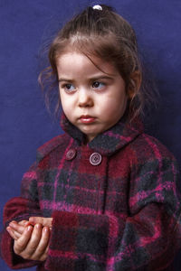 Portrait of a smiling girl over black background