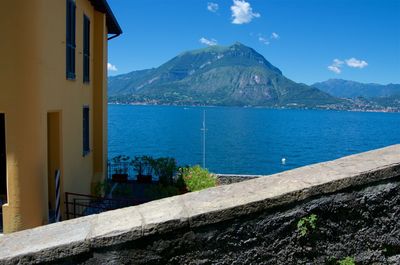 Scenic view of sea by buildings against sky