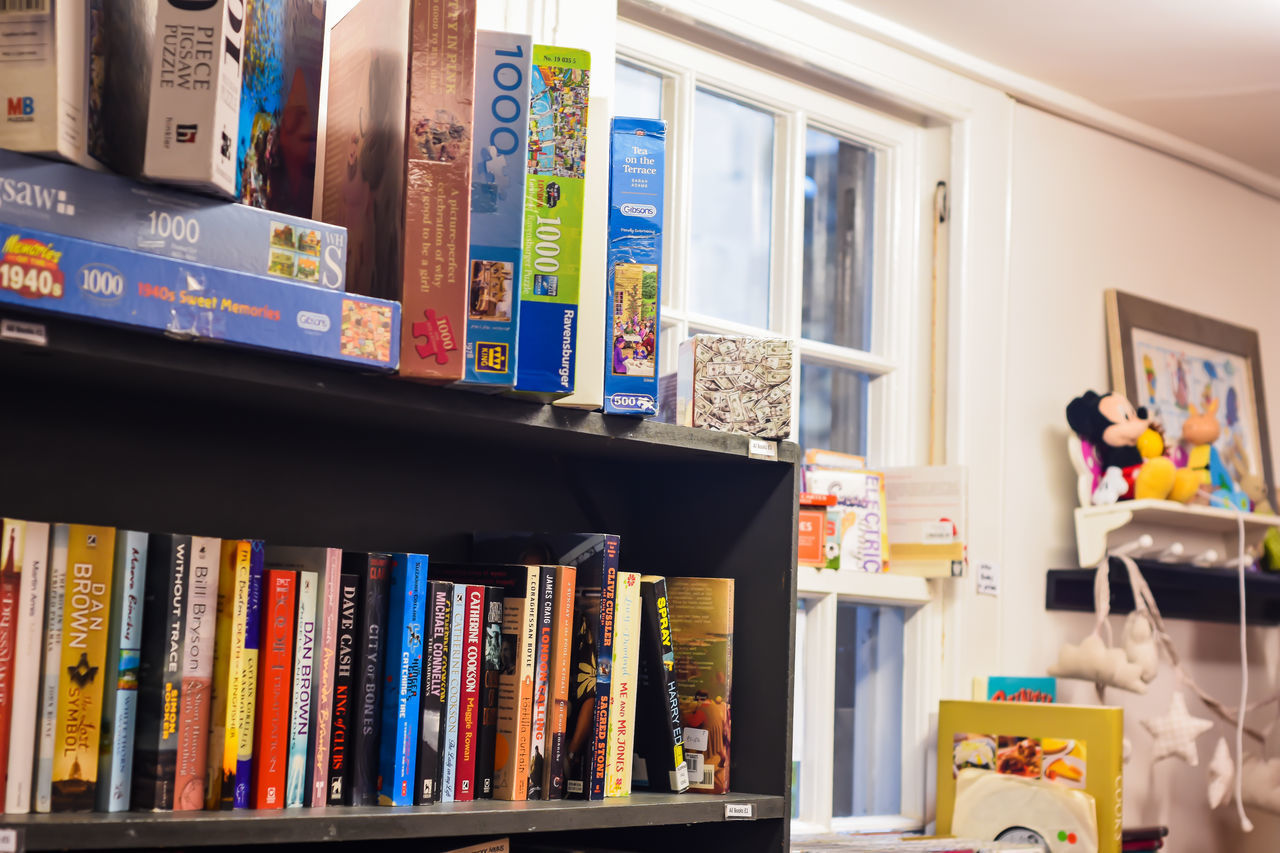 VARIOUS BOOKS ON SHELF IN BOOK