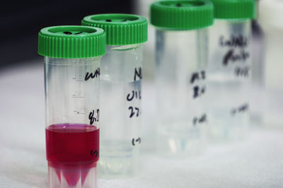 Close-up of containers with liquid on table in laboratory