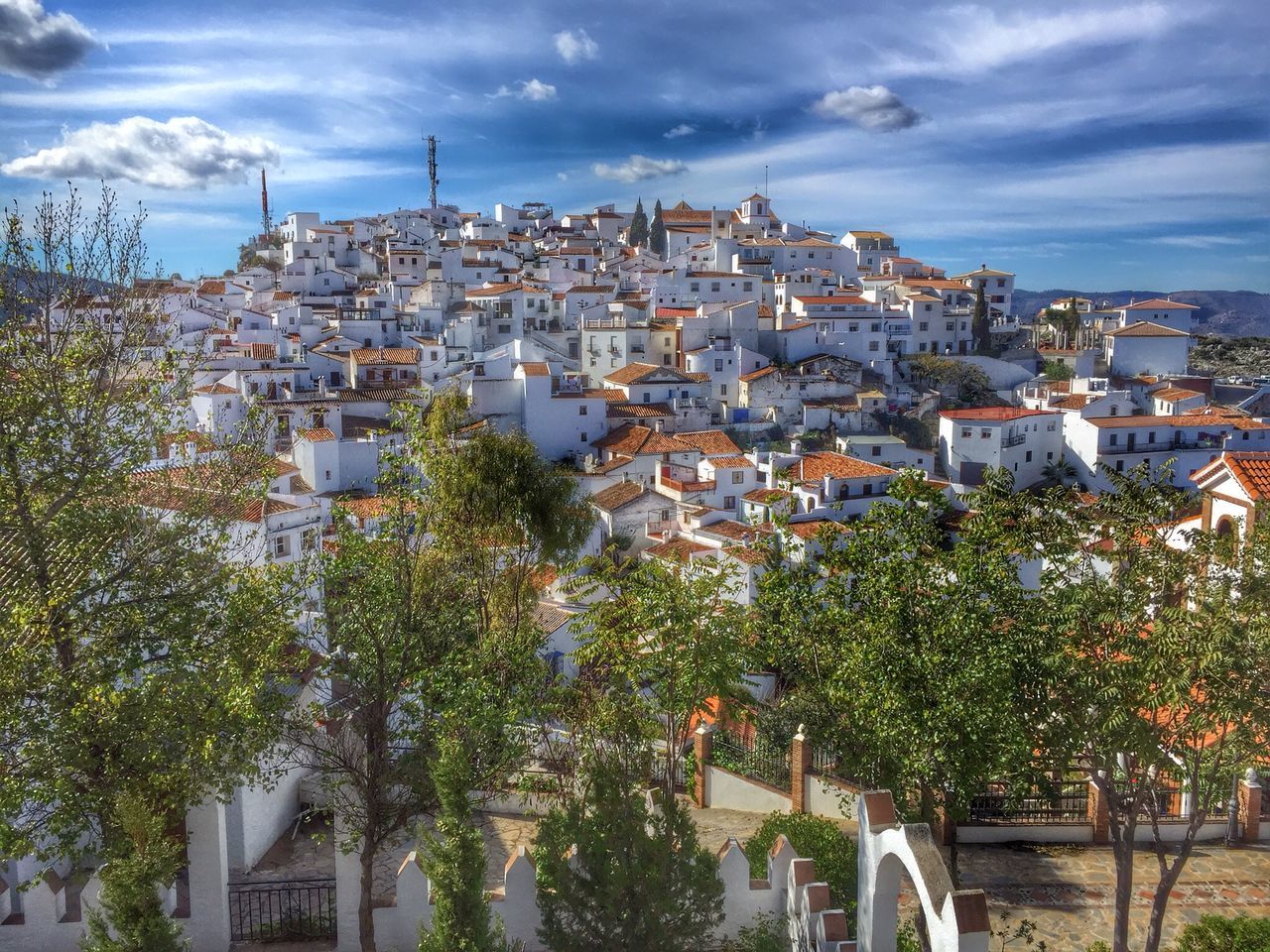 building exterior, architecture, built structure, sky, residential structure, residential building, tree, city, house, residential district, cityscape, cloud - sky, high angle view, cloud, roof, town, crowded, growth, townscape, day