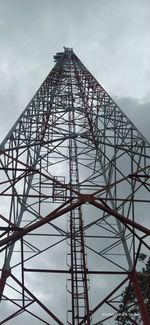 Low angle view of communications tower against sky