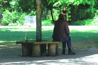 Full length of woman standing on tree trunk