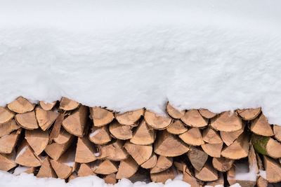 Stack of logs in snow