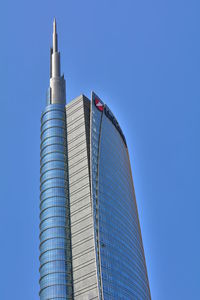 Low angle view of modern building against blue sky