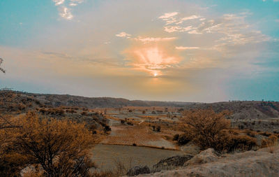 Scenic view of landscape against sky during sunset