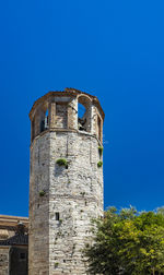 Low angle view of old building against clear blue sky