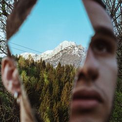 Close-up of man with mirror at park