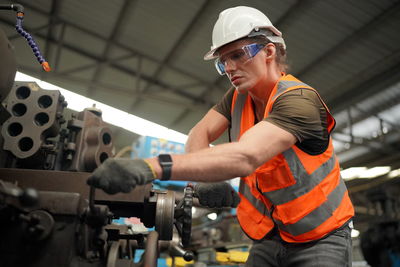 Portrait of male worker standing in the heavy industry manufacturing factory.