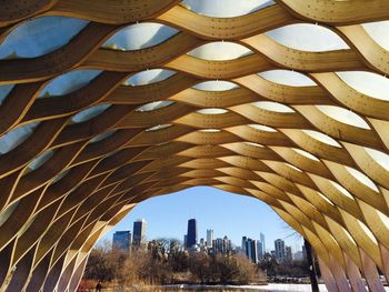 Low angle view of designed arch against city