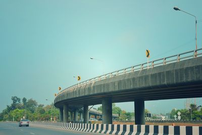 Bridge over road against clear sky