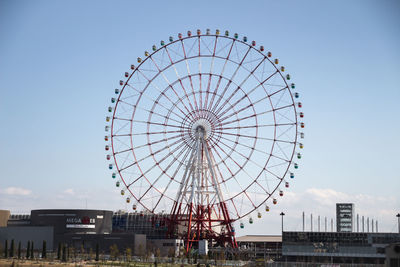 Low angle view of ferris wheel against sky