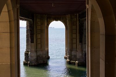 Sea seen through arch of building