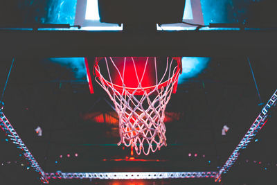 Low angle view of basketball hoop at night