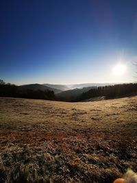 Scenic view of land against clear blue sky