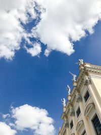 Low angle view of building against cloudy sky