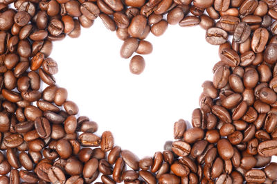 Close-up of coffee beans against white background