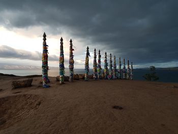 Metallic structure on land against sky during sunset